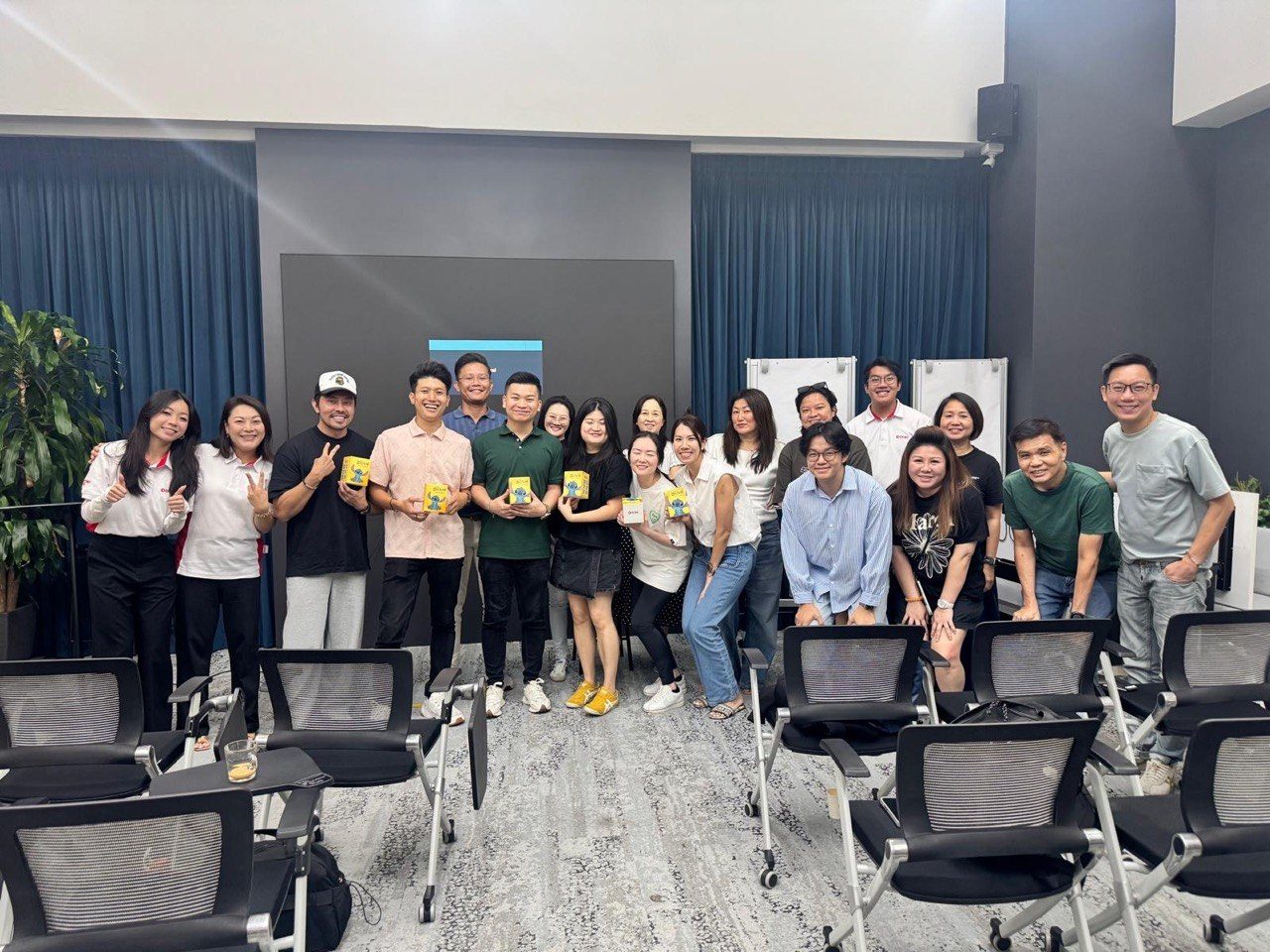 Team holding yellow gift boxes together